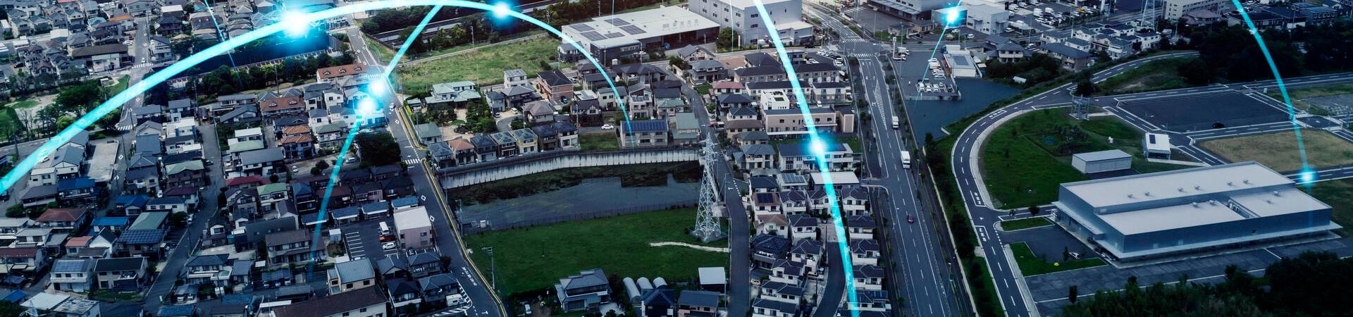 Stadt aus Vogelperspektive mit grafisch dargestellten Netzwerkverbindungen